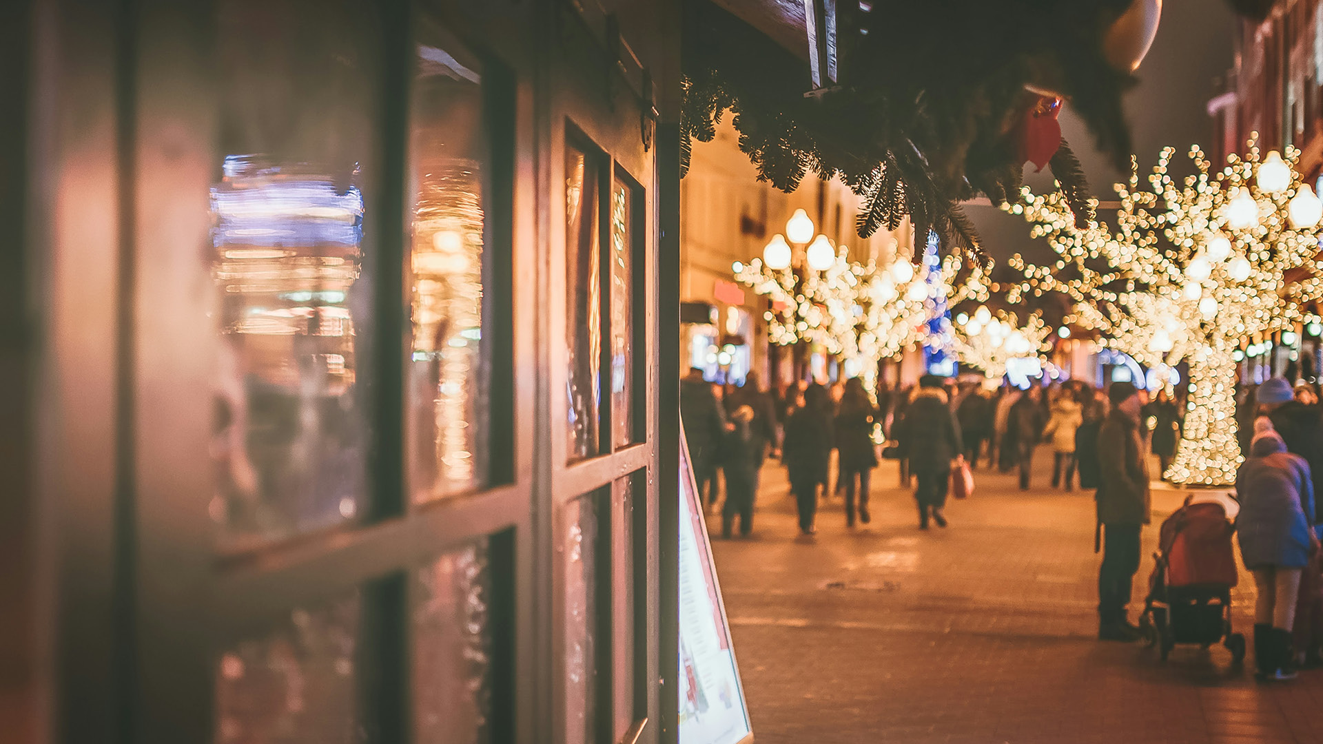people walking around a christmas market