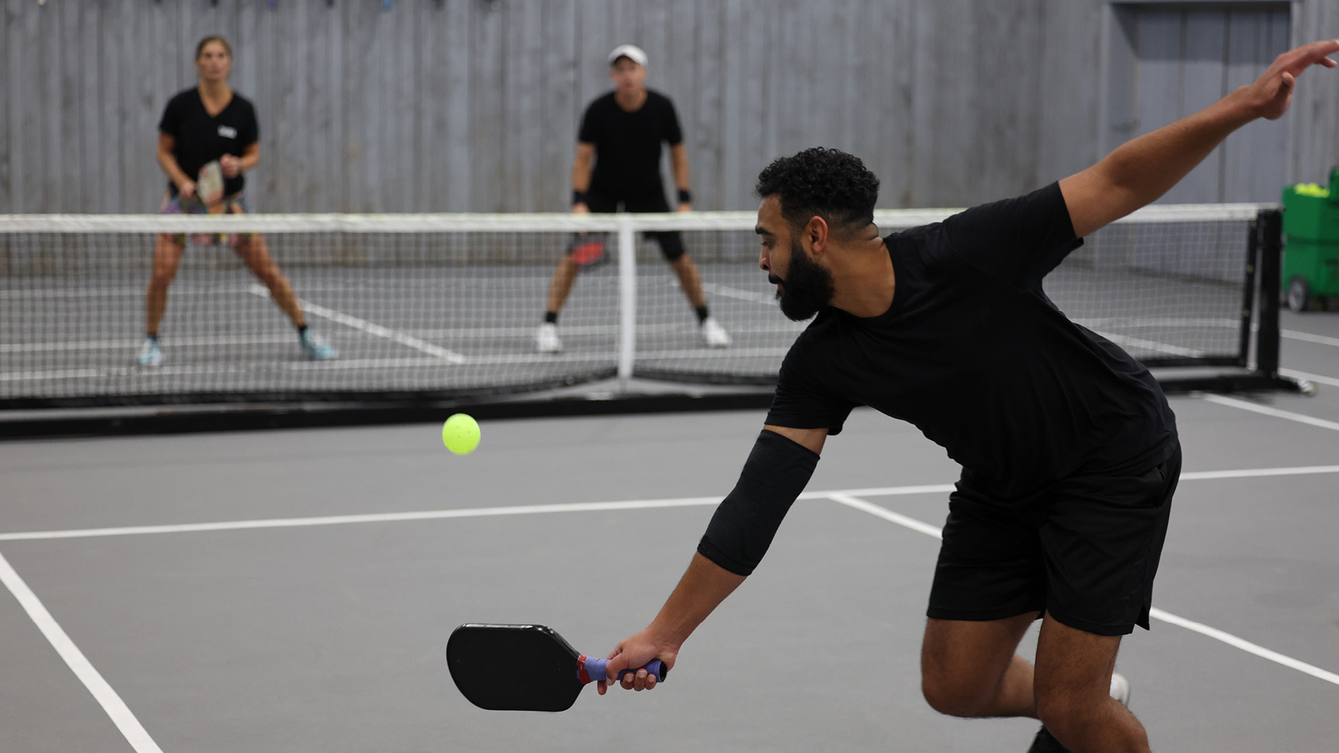 person playing pickle ball indoors